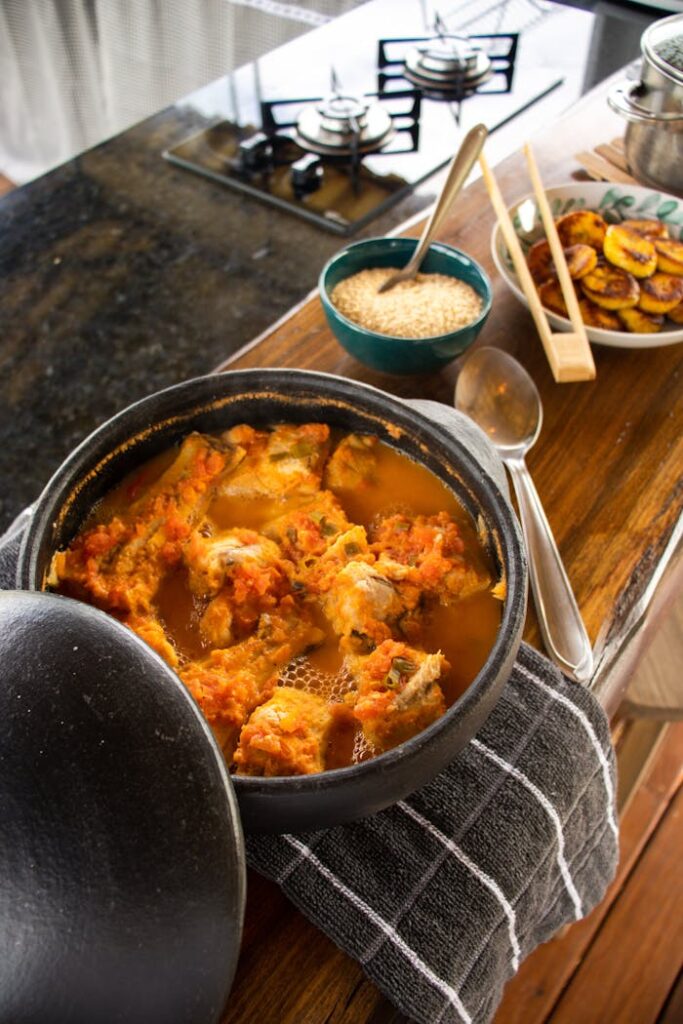 Delicious Brazilian moqueca in a clay pot with rice and plantains, perfect for food enthusiasts.